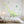 Children's room with a large dinosaur wall decal and leaf stickers on the wall.