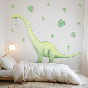 Children's room with a large dinosaur wall decal and leaf stickers on the wall.
