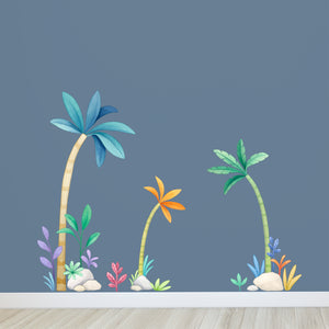 Colorful palm tree and plant wall decals on a blue wall.