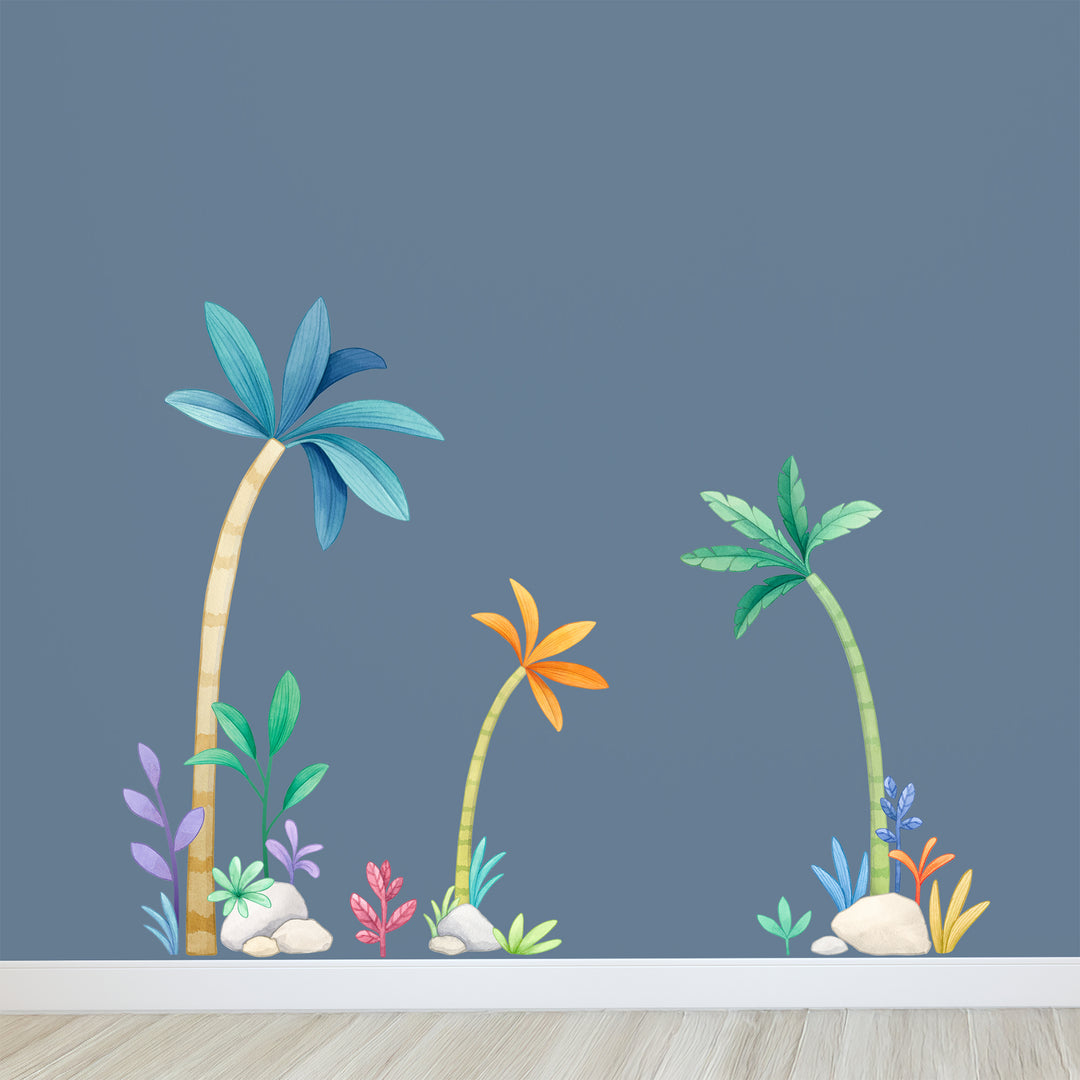 Colorful palm tree and plant wall decals on a blue wall.