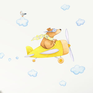 A bear in a yellow airplane decal